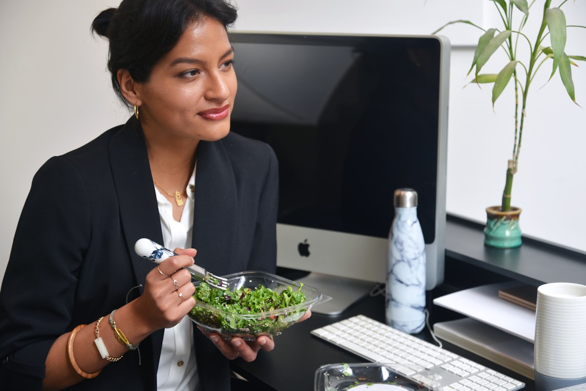 Woman enjoying healthy nutritious meal with colorful vegetables and fruits